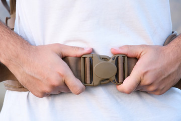 the young man was completely locked himself fastex buckle on the belly from the backpack