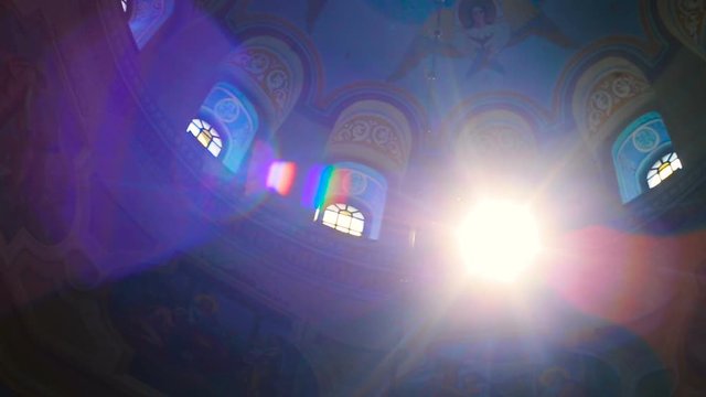 Colorful stained-glass windows at Gothic Cathedral, POV camera move inside