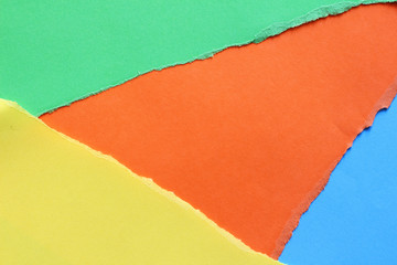 Pieces of colored torn paper as a background. copy space