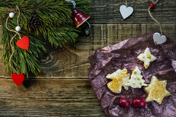 Christmas fir tree with decoration on dark wooden board