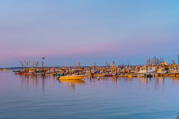 Fototapeta na wymiar Ships and boats in the Provincetown Marina during sunset Provincetown, MA
