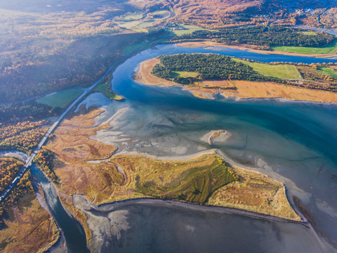 Classic norwegian scandinavian summer mountain landscape view with road, mountains and fjord with a blue sky, northern Norway, Finnmark County, shot from drone