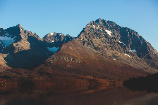 Beautiful vibrant summer view of Norwegian mountains and fjord reflection, Lyngen Alps, Finnmark county, northern Norway