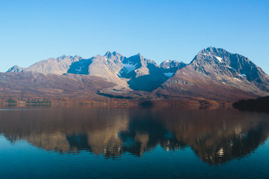 Beautiful vibrant summer view of Norwegian mountains and fjord reflection, Lyngen Alps, Finnmark county, northern Norway