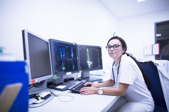 Hospital radiologist in front of scans.