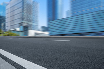 Empty urban road and modern skyline.