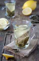 Hot green tea with lemon in glass mugs