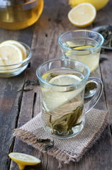 Hot green tea with lemon in glass mugs