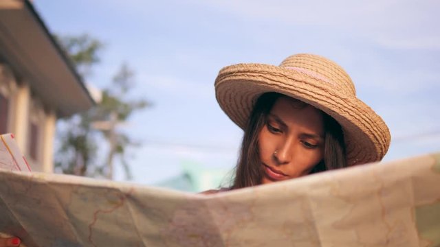 Young Mixed Race Tourist Woman Exploring City Map. Attractive Hipster Girl Traveling in Thailand. 4K, Slowmotion.
