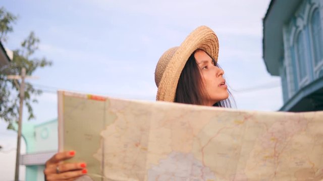 Attractive Hipster Girl Exploring City Map in Old Town. Young Mixed Race Tourist Woman Traveling in Thailand. 4K, Slowmotion.