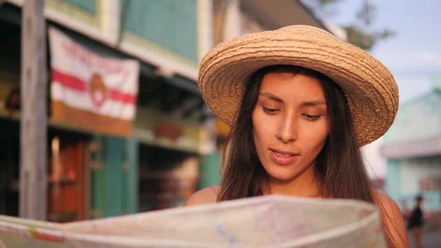 Attractive Smiling Girl Looking at City Map and Admiring Old Town Buildings. Young Mixed Race Tourist Woman Traveling in Thailand. 4K, Slowmotion.