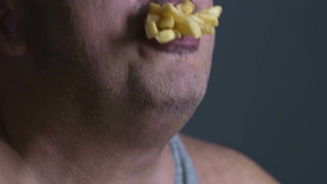 Fast food addict eating french fries, inability to resist unhealthy foodstuff