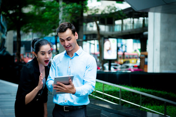 Young business leaders concept. Young Business man discussing work with woman co worker outdoor in city.