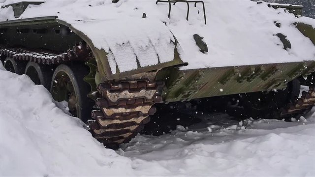 Snow on the background of the tank caterpillar 