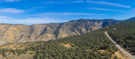 Naklejka premium Highway runs across a mountain ridgeline in the California wilderness.