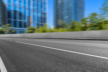 city empty traffic road with cityscape in background.