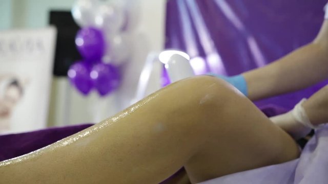 A woman's hand rips the hair out of her feet with a sugar mass for a shugaring