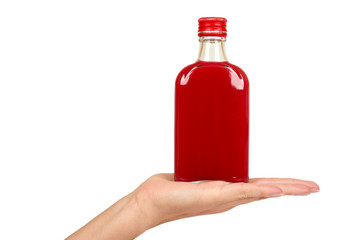 Glass bottle with red tincture in hand isolated on white background. Alcohol problem