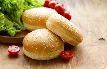 fresh homemade burger buns on a wooden table