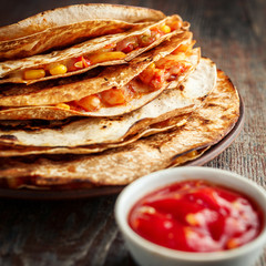 Mexican quesadilla and salsa on a wooden table