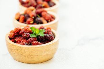 Black mulberry fruit in bowl
