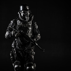 Naklejka premium Futuristic nazi soldier gas mask and steel helmet with schmeisser handgun black background studio shot