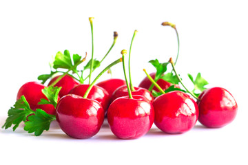 Fresh red cherries lay on white isolated background in side view, close up. Cherry have high vitamin C and have sweet and sour taste. Healthy and delicious fruit concept.