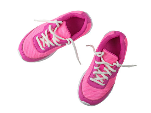 Womens pink sneakers with untied white laces isolated on white background.