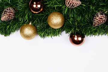 Christmas holiday background. Christmas still life. Gold glitter ball, star, spruce branches and decorative christmas ornaments on a white background with copy-space. Top view.