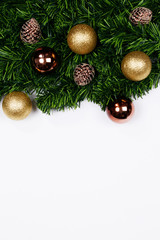 Christmas holiday background. Christmas still life. Gold glitter ball, star, spruce branches and decorative christmas ornaments on a white background with copy-space. Top view.