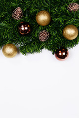 Christmas holiday background. Christmas still life. Gold glitter ball, star, spruce branches and decorative christmas ornaments on a white background with copy-space. Top view.