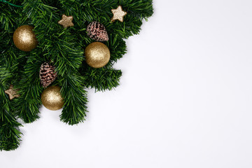 Christmas holiday background. Christmas still life. Gold glitter ball, star, spruce branches and decorative christmas ornaments on a white background with copy-space. Top view.