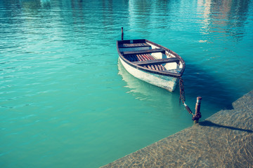 Fototapeta na wymiar Landscape with lake and boat. Boat near pier
