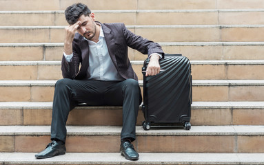 Stress out handsome white male business man or sale man sitting on stair.