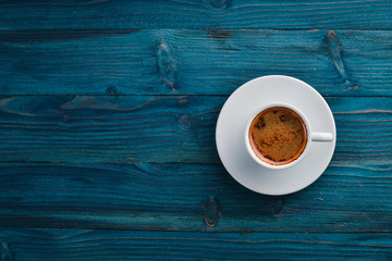 A cup of espresso coffee on a dark wooden background. Top view. Free space for text.