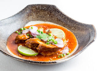 spicy sardine in tomato sauce (caned fish) in ceramic dish