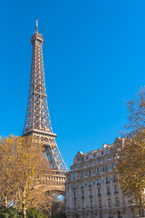 Paris, Eiffel tower, panorama, near typical facade in a chic area of the capital
