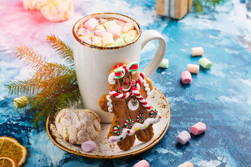 Hot chocolate with marshmallows and cookies on Christmas background