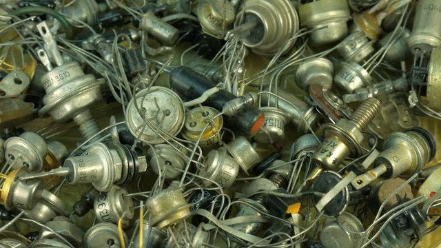 Background pile of old Radio components, diode end transistor with led bulbs.