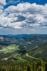 Green mountain valley and the winding mountain road. Summer in the Rocky Mountains