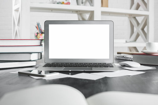 Light office desktop with clean laptop screen