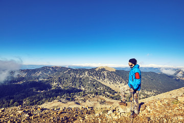 Fototapeta premium Hiking in the mountains with a backpack in the summer.