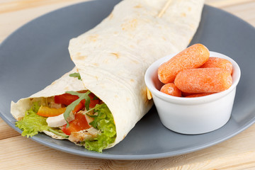 Tortilla in the grey plate on the wooden table