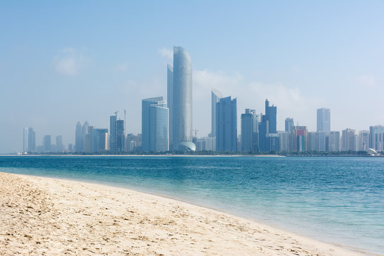 View to Abu Dhabi skyline from the beach, United Arab Emirates.