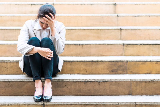 Depress Woman Sitting On Staircase Outside.