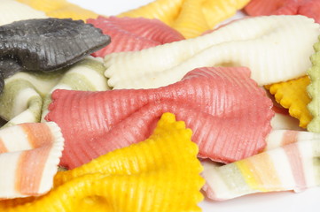 Beautiful colorful pasta in the shape of a butterfly isolated on white background. Striped pasta on a white background.