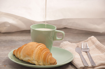 Croissant and cup of milk