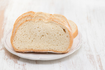 white bread on white plate on white wooden background