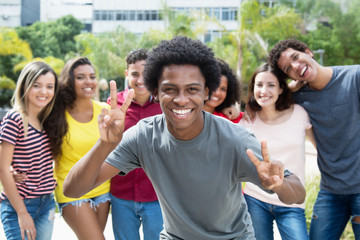 Cheering african american guy with group of international friends