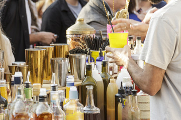 Barman is making cocktail on festival